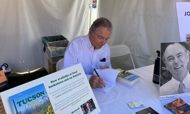 John Warnock signing his books