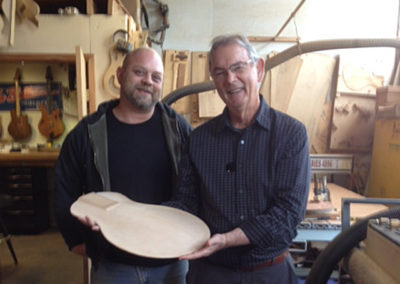 Vincent on the left and John on the right examine part of John's guitar